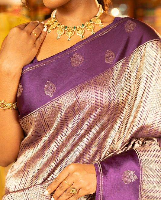Purple Russian Dola Silk Saree, Meticulously Crafted with Zari Zig-Zag Jacquard on Its Body, Highlighted by Zari Buttas Woven Satin Border, Intricately Designed Pallu, and Paired with a Matching Blouse