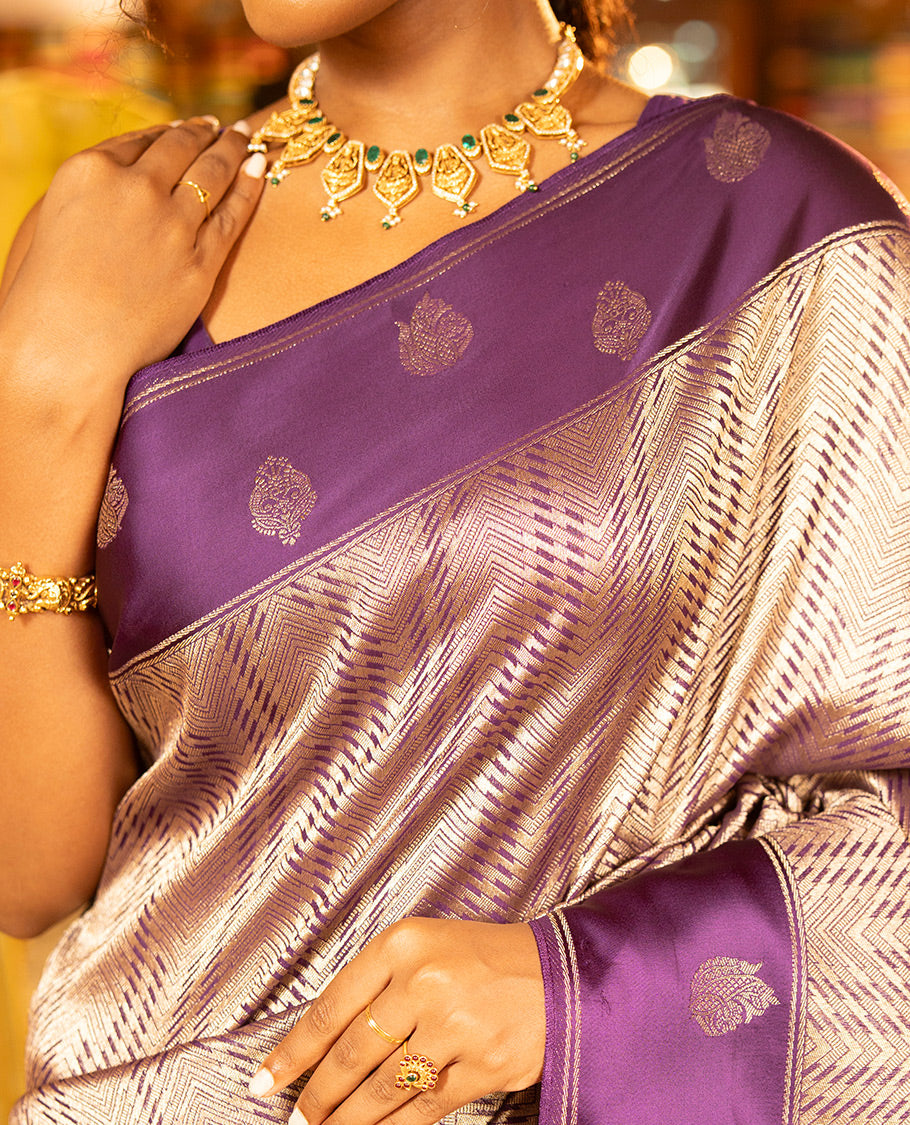 Purple Russian Dola Silk Saree, Meticulously Crafted with Zari Zig-Zag Jacquard on Its Body, Highlighted by Zari Buttas Woven Satin Border, Intricately Designed Pallu, and Paired with a Matching Blouse