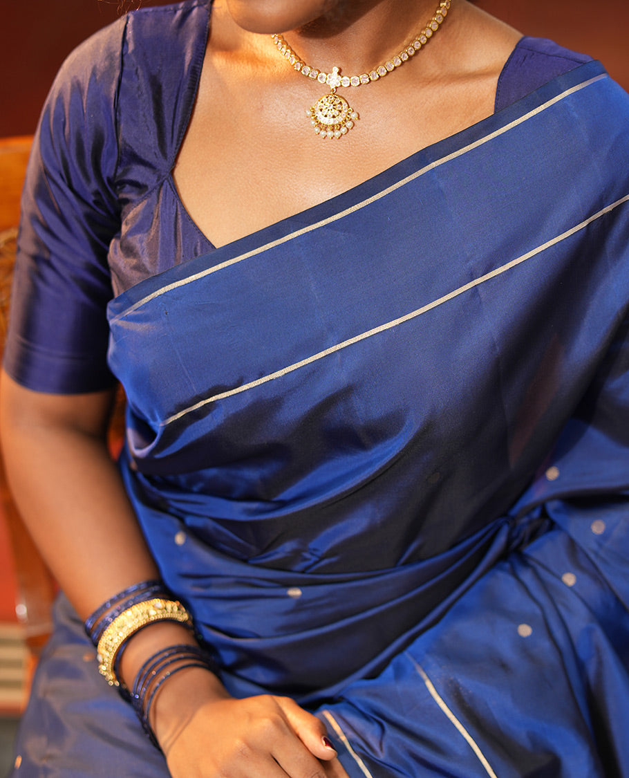 Navy Blue Vasundhara Lite Silk Saree, Subtly Sparkled with Paisa Zari Buttas Across Its Body, Highlighted Zari Border of Horizontal Stripes, Gleaming Pallu of Seppu Rekku Designs, and Paired with a Matching Blouse