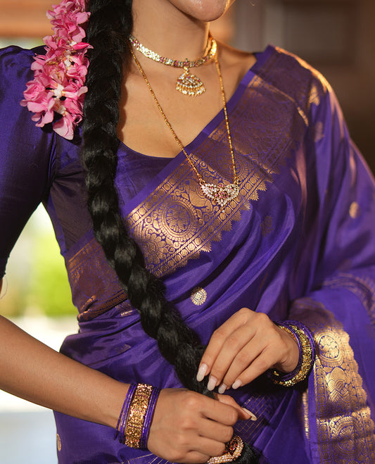 Violet Vasundhara Lite Silk Mix Saree, Artfully Detailed with Mayil-Chakram Buttas and Zari Checks All Over Its Body, Highlighted by a Zari Border of Thazampoo Rekkum, Paisa, Mayil, and Chakram Designs, a Grand Pallu, and Paired with a Matching Blouse