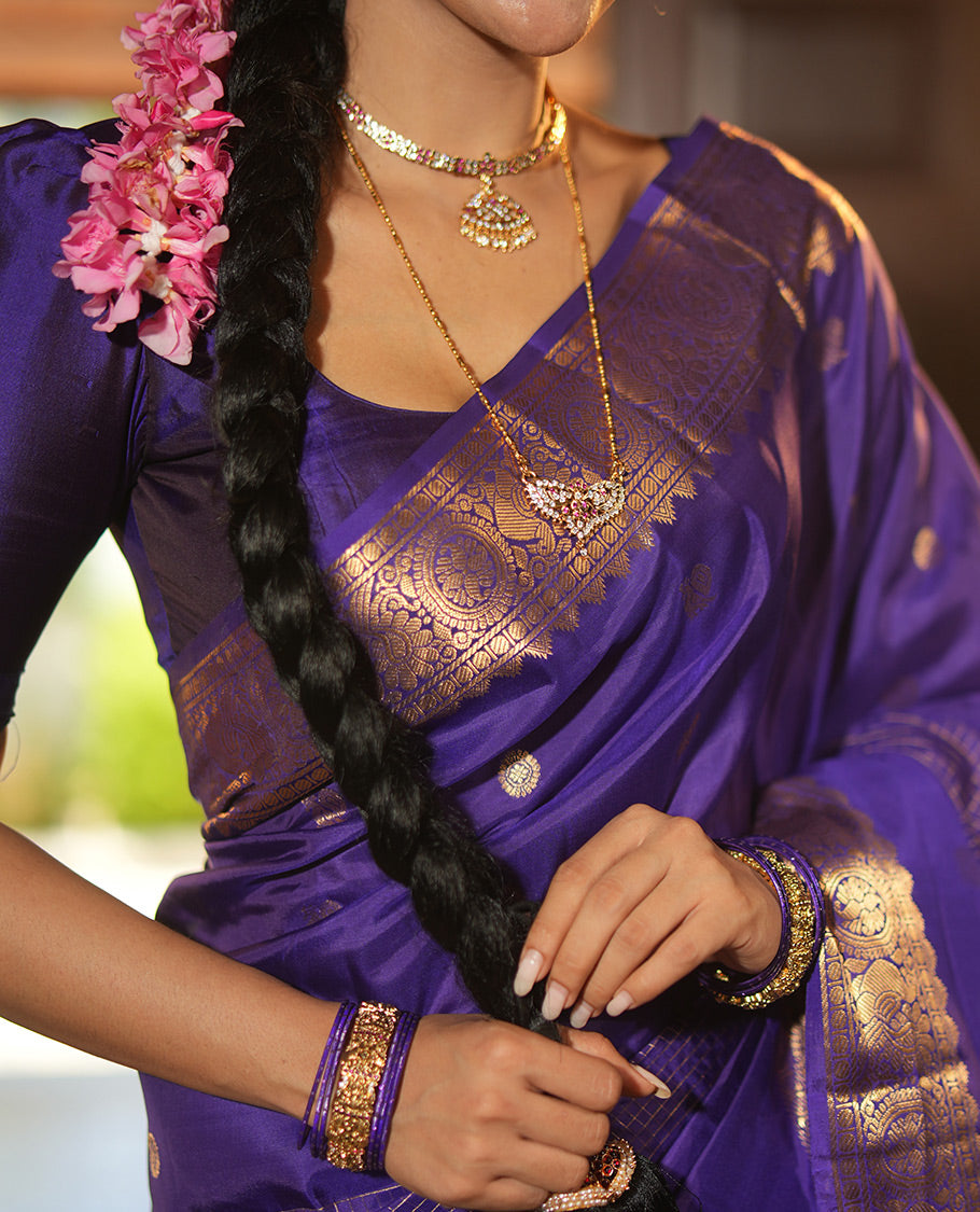 Violet Vasundhara Lite Silk Mix Saree, Artfully Detailed with Mayil-Chakram Buttas and Zari Checks All Over Its Body, Highlighted by a Zari Border of Thazampoo Rekkum, Paisa, Mayil, and Chakram Designs, a Grand Pallu, and Paired with a Matching Blouse