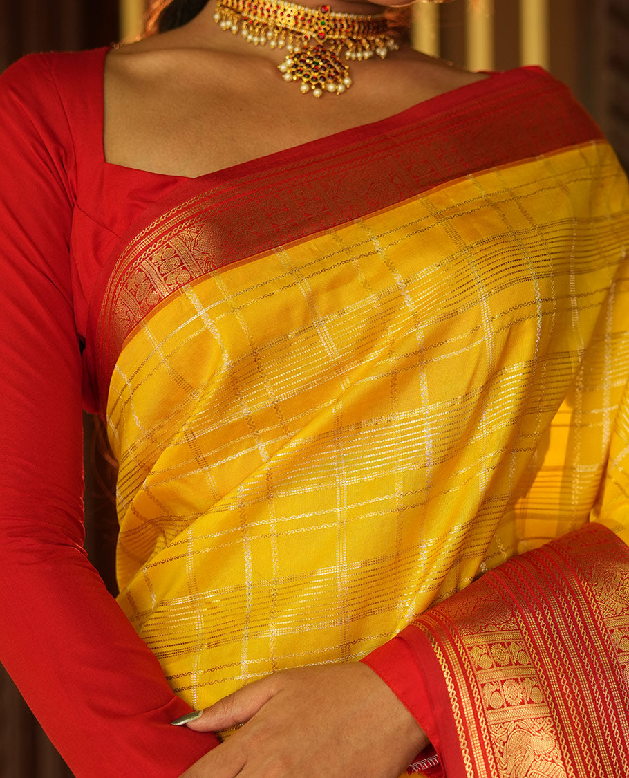 Lemon Yellow and Red Vasundhara Lite Silk Saree, Richly Detailed with Zari Checked Design On Its Body, Complemented by Contrast Varisai Pettu Border of Mayil Chakram Designs, Grand Jaal Pallu, and Paired with a Contrast Blouse