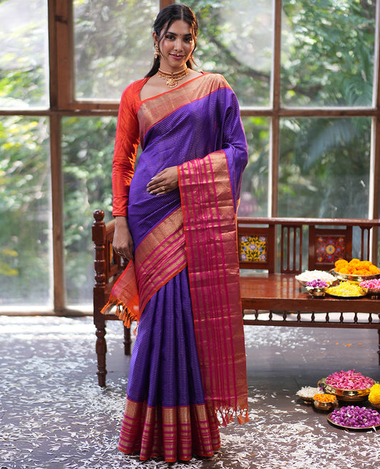 Violet and Pink Vasundhara Silk Saree, Enriched with Zari Stripes All Over Its Body, Complemented by Contrast Border of Thilakam Mokku, Muthu, Mayil, Neli, and Cross Kamalam Designs, Jaal Pallu, and Paired with a Veldhari With Bordered Blouse