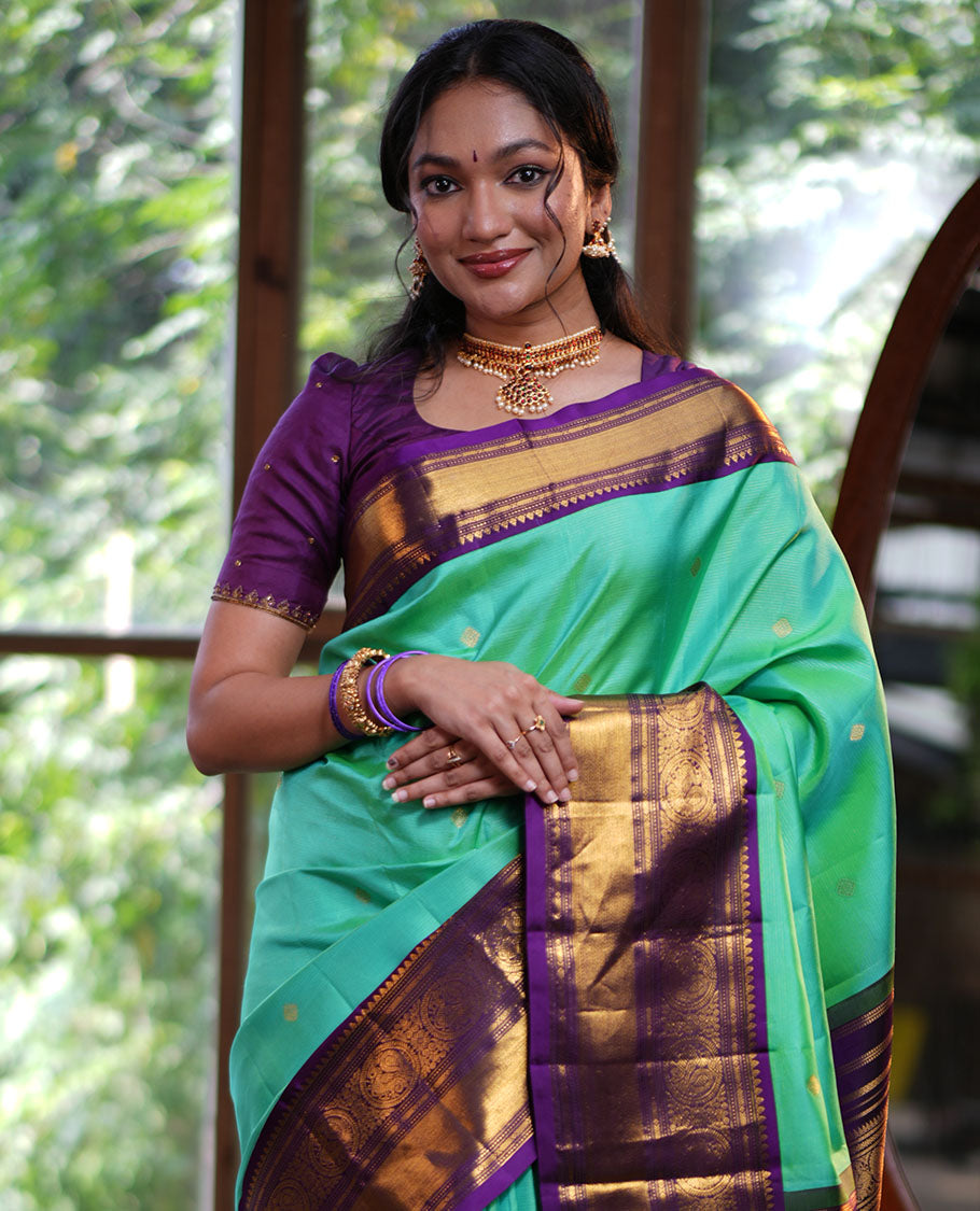 Rexona Green Vasundhara Silk Saree, Beautified with Sparse Stripes and Zari Buttas, Complemented by a Contrast Border of Thilakam, Banaras, Muthu, and Round Mayil Designs, Pallu Steeped with Traditional Designs, and Paired with a Contrast Blouse