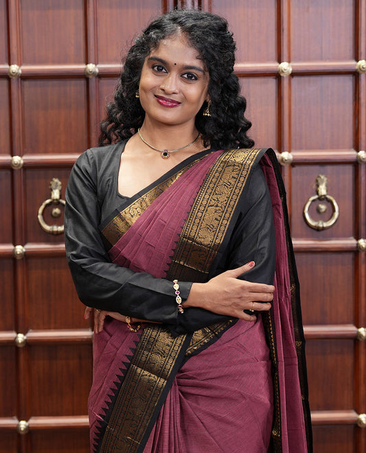 Reddish Brown Plain Chettinad Cotton Saree, Complemented by a Contrast Traditional Rettai Pettu Temple Border of Peacock-Elephant Designs, Subtly Striped Pallu, and Paired with a Matching Blouse
