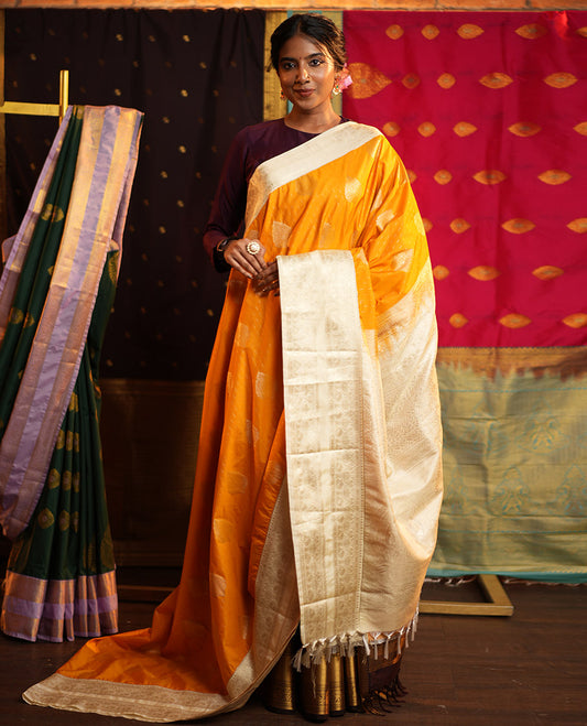 Yellow Budget Silk Saree, Steeped in the Richness of Zari Buttas All Over Its Body, Complemented by Contrast Varisai Pettu Traditional Zari Design Border, an Intricately Designed Pallu, and Paired with a Contrast Blouse
