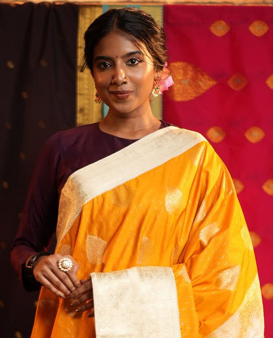 Yellow Budget Silk Saree, Steeped in the Richness of Zari Buttas All Over Its Body, Complemented by Contrast Varisai Pettu Traditional Zari Design Border, an Intricately Designed Pallu, and Paired with a Contrast Blouse