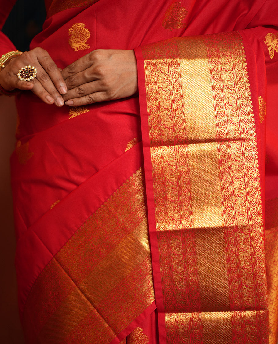 Red Budget Silk Saree, Gleamed Up with Zari Buttas on Its Body, Highlighted by a Zari Border of Traditional Designs, Grand Jaal Design Border, and Paired with a Matching Blouse