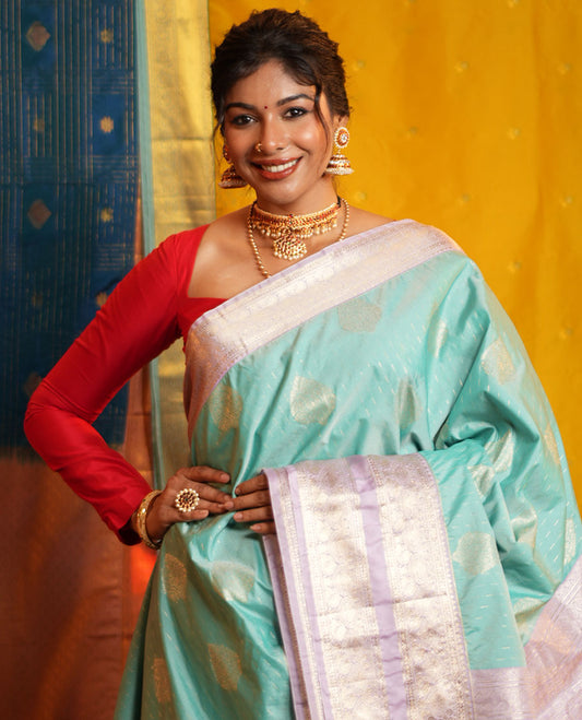 Blue Budget Silk Saree, Steeped in the Richness of Zari Buttas All Over Its Body, Complemented by Contrast Varisai Pettu Traditional Zari Design Border, an Intricately Designed Pallu, and Paired with a Contrast Blouse