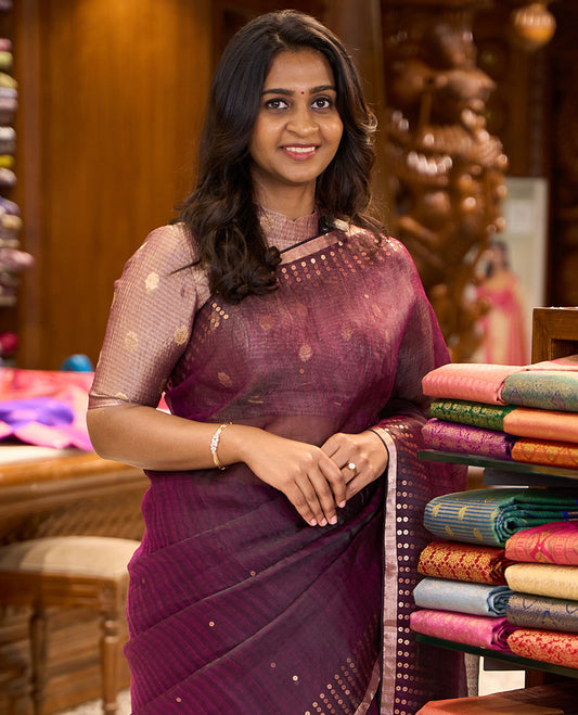Wine sparsely striped saree, gleaming zari border features polka dots, and pallu steeped with polka dots