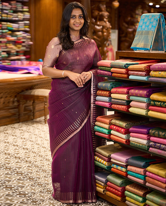 Wine sparsely striped saree, gleaming zari border features polka dots, and pallu steeped with polka dots