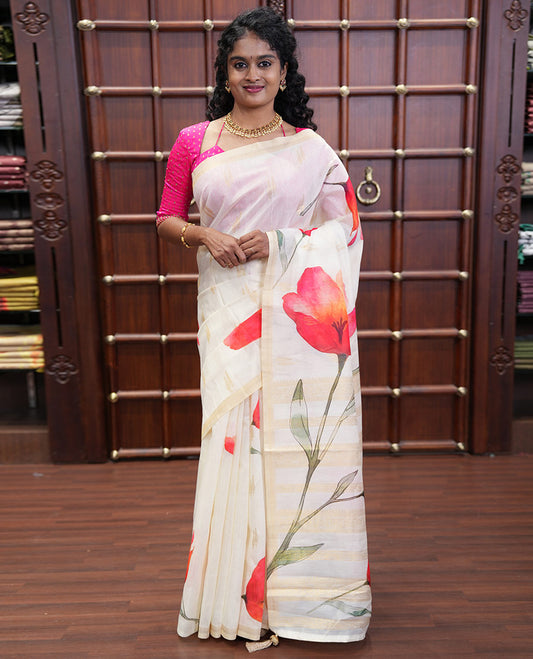 Cream Banaras Tissue Saree, Adorned with Floral Motifs Print and Zari Buttas on Its Body, Subtly Bordered, Pallu Pictures Floral Prints, and Paired with a Matching Printed Blouse