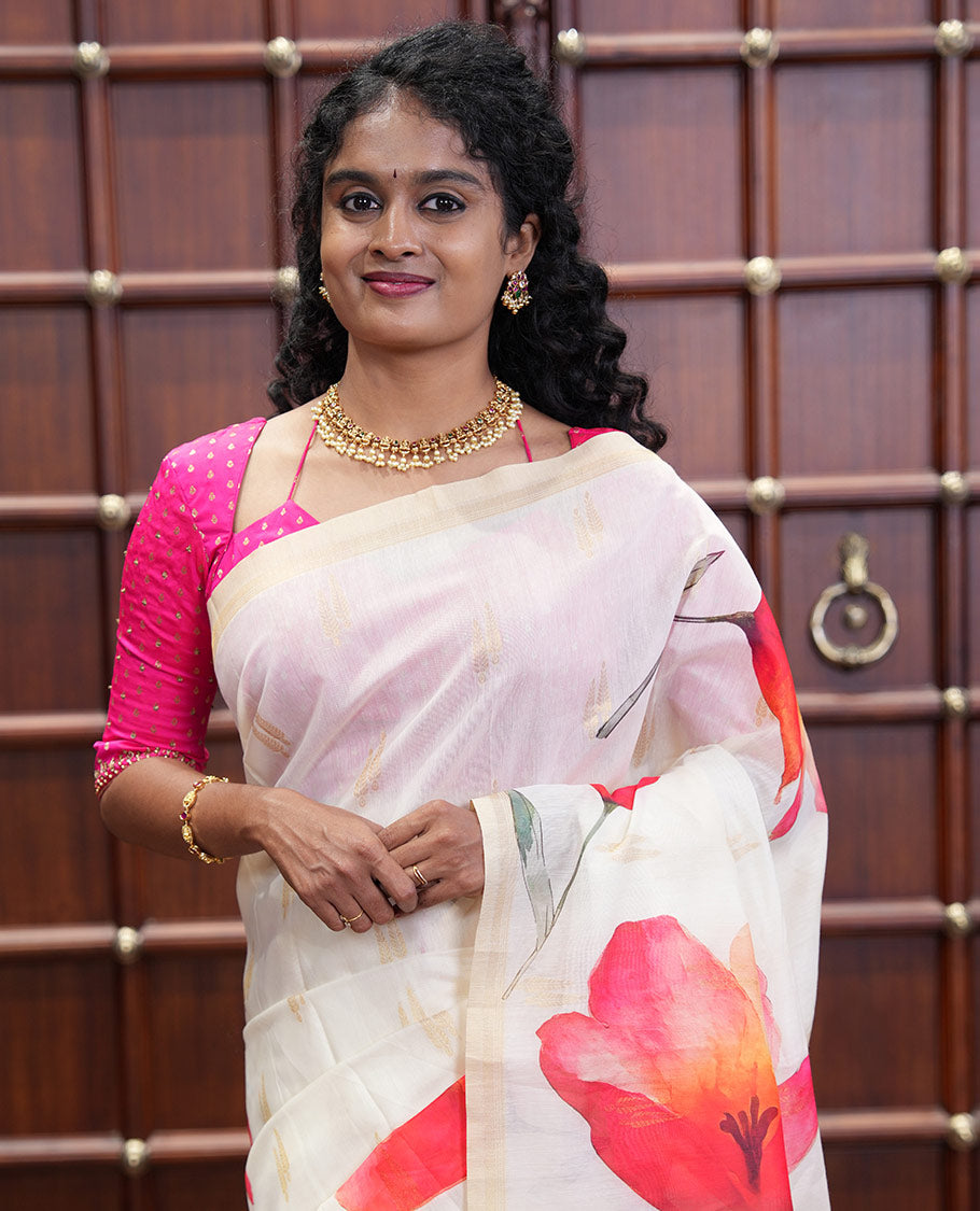Cream Banaras Tissue Saree, Adorned with Floral Motifs Print and Zari Buttas on Its Body, Subtly Bordered, Pallu Pictures Floral Prints, and Paired with a Matching Printed Blouse