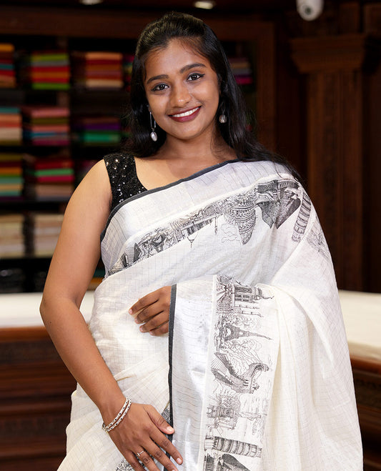 Half-white zari checked Kerala saree,bavanji border & pallu delicately printed with 7-wonders of the world motifs, zari design blouse
