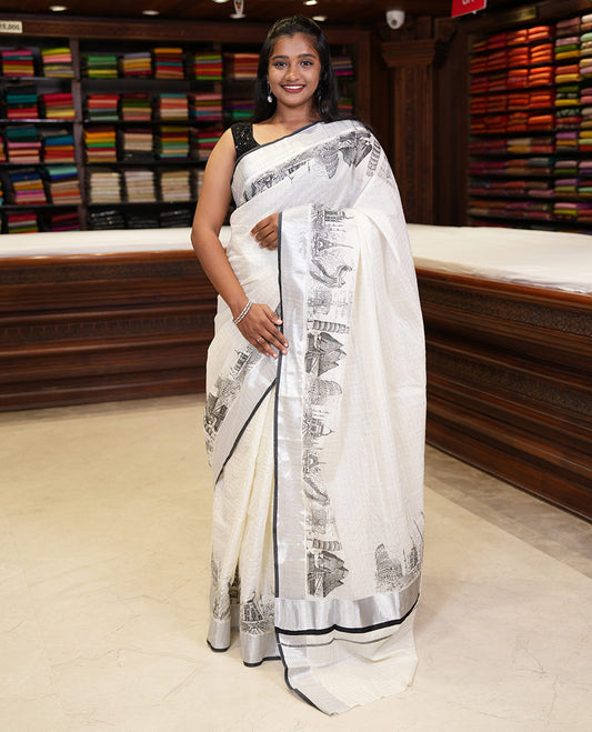 Half-white zari checked Kerala saree,bavanji border & pallu delicately printed with 7-wonders of the world motifs, zari design blouse