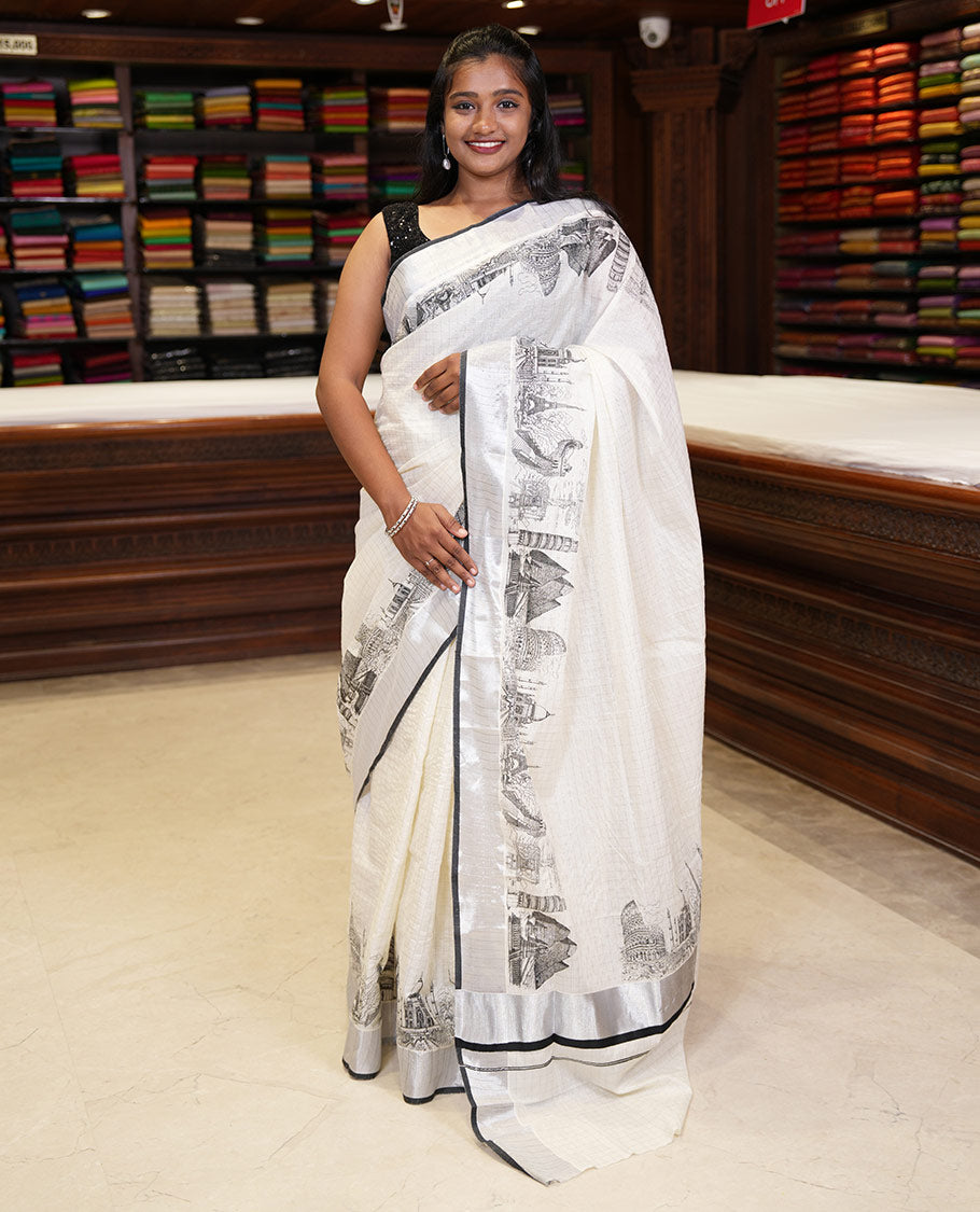 Half-white zari checked Kerala saree,bavanji border & pallu delicately printed with 7-wonders of the world motifs, zari design blouse