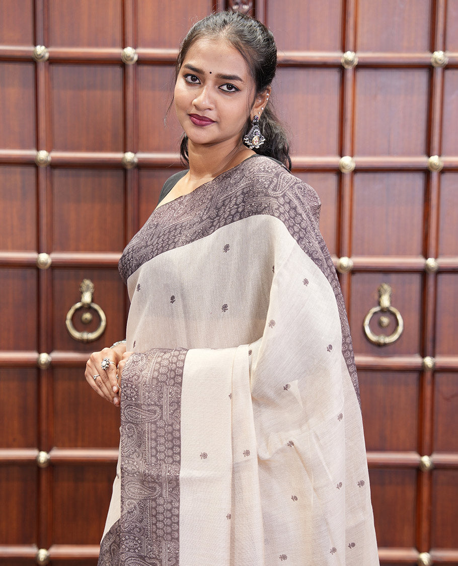 Chikku and Black Tissue Linen Saree, Delicately Printed with Floral Motifs on Its Body, Complemented by a Contrast Border of Paisley Designs, Pallu Steeped with Paisley Designs, and Paired with a Contrast Blouse