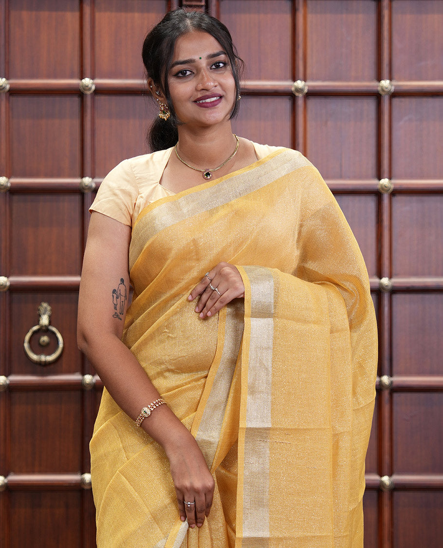 Yellow Tissue Saree, Gleamed Up with Zari Striped on Its Body, Highlighted by a Zari Border, Pallu Steeped with Zari Stripes, and Paired with a Matching Blouse