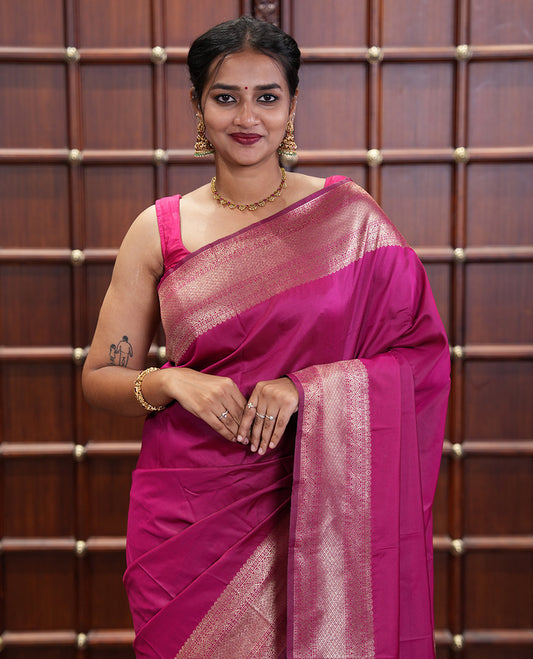 Pink Plain Semi-Soft Silk Saree, Elevated with Traditional Zari Designs Woven Border, Grandly Woven Pallu Steeped with Chakram Designs, and Paired with a Matching Blouse