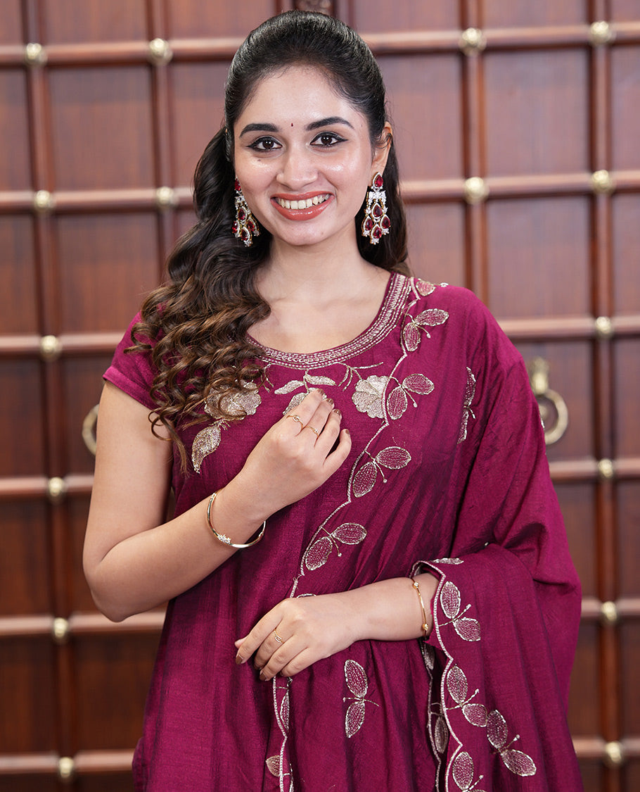 Wine Material Chudidhar Set, Highlighted with an Floral Motifs Embroidered on its Vichitra Silk Top, Plain Santoon Bottom, and Vichitra Silk Dupatta of Leaf Motifs Embroidery