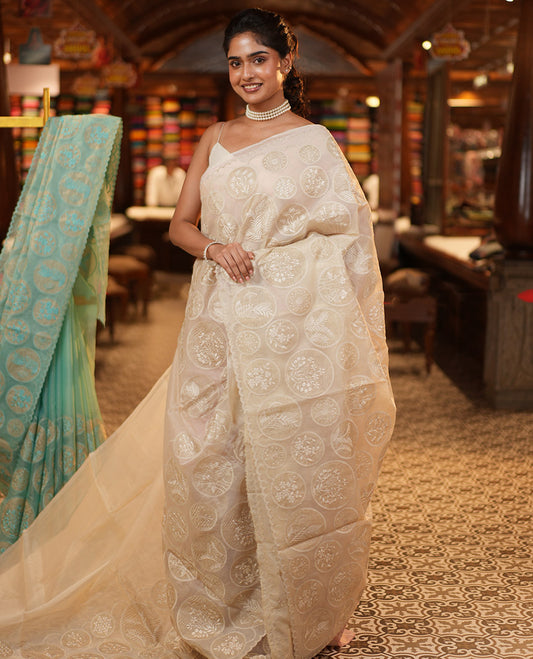 Off-White Organza Saree, Delicately decked Up with Floral Enclosed Circle Motifs Thread Embroidery, Subtle Scallop Border, Delicately Embroidered Pallu, and Paired with a Matching Embroidered Blouse