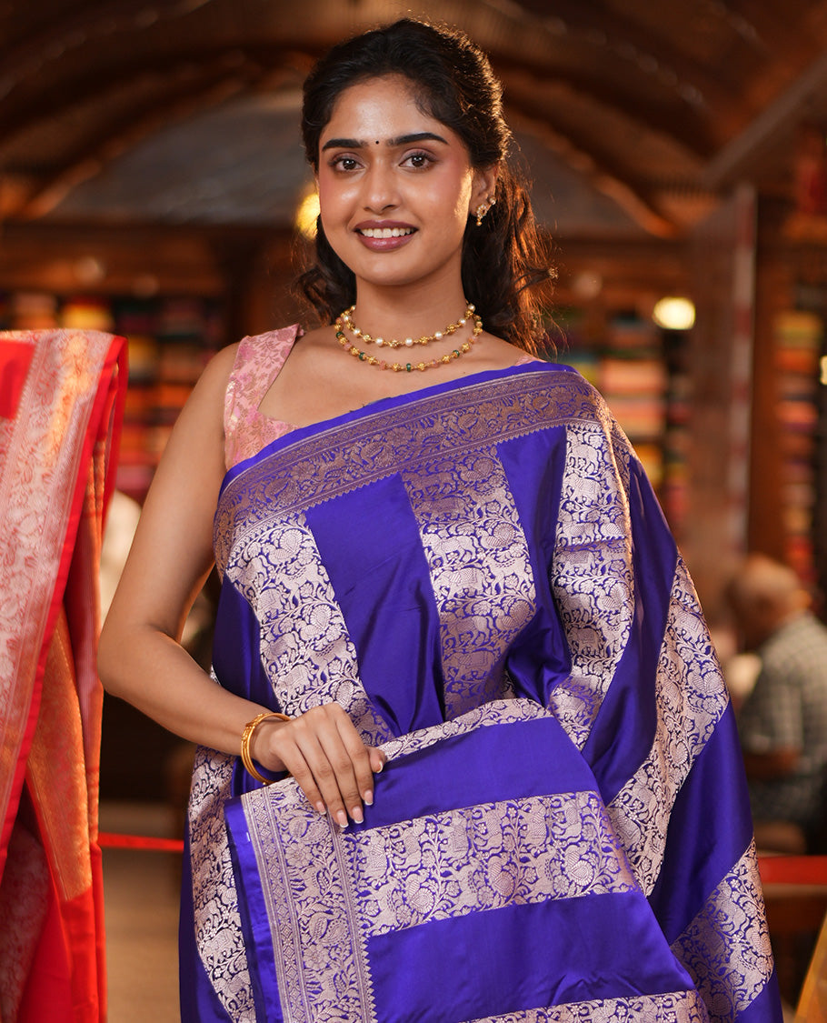 Blue Mushuru Silk Saree, Elegantly Decked Up with Vertically Woven Flora-Fauna Zari Designs On Its Body, Highlighted by Zari Border of Peacock and Deer Motifs, Grand Pallu, and Paired with a Plain Blouse