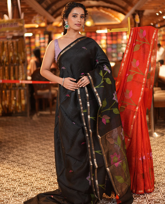 Black Matka Silk Saree, Artfully Woven With Jamdani-Style Leaf Motifs and Floral Design On Its Body, Subtle Piping Border, Tissue Pallu of Jamdani Floral Weave, and Paired with a Contrast Blouse