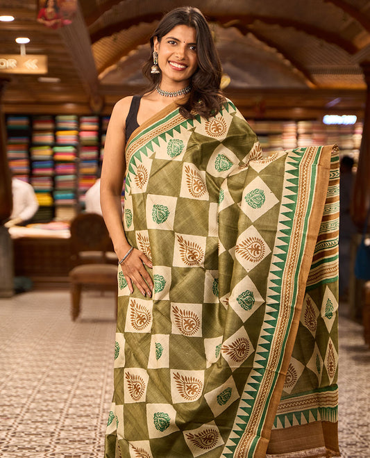 Olive green block floral print tussar saree with contrast geometric design border & floral design pallu