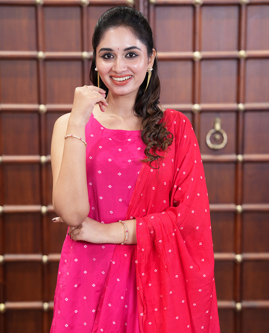Pink and Red Semi-Silk Material Churidar Set, Prettified with Bandhani Dots Print, Comes with a Plain Santoon Bottom, and Paired with a Double-Colored Dupatta of Bandhani Dots Print