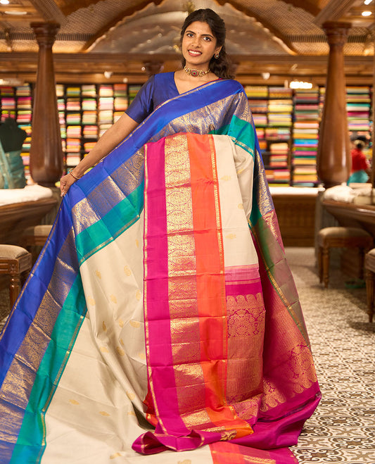 White buttas buttas kancheepuram silk saree with contrast ganga jamuna, korvai border of intricate zari design & floral design pallu