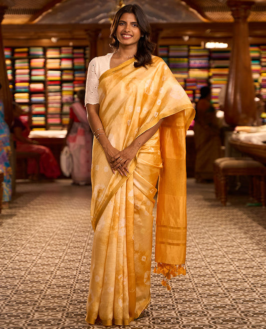Yellow shibori motifs printed Banana pith saree, golden zari bavanji border, and pallu steeped with sparse gold lines
