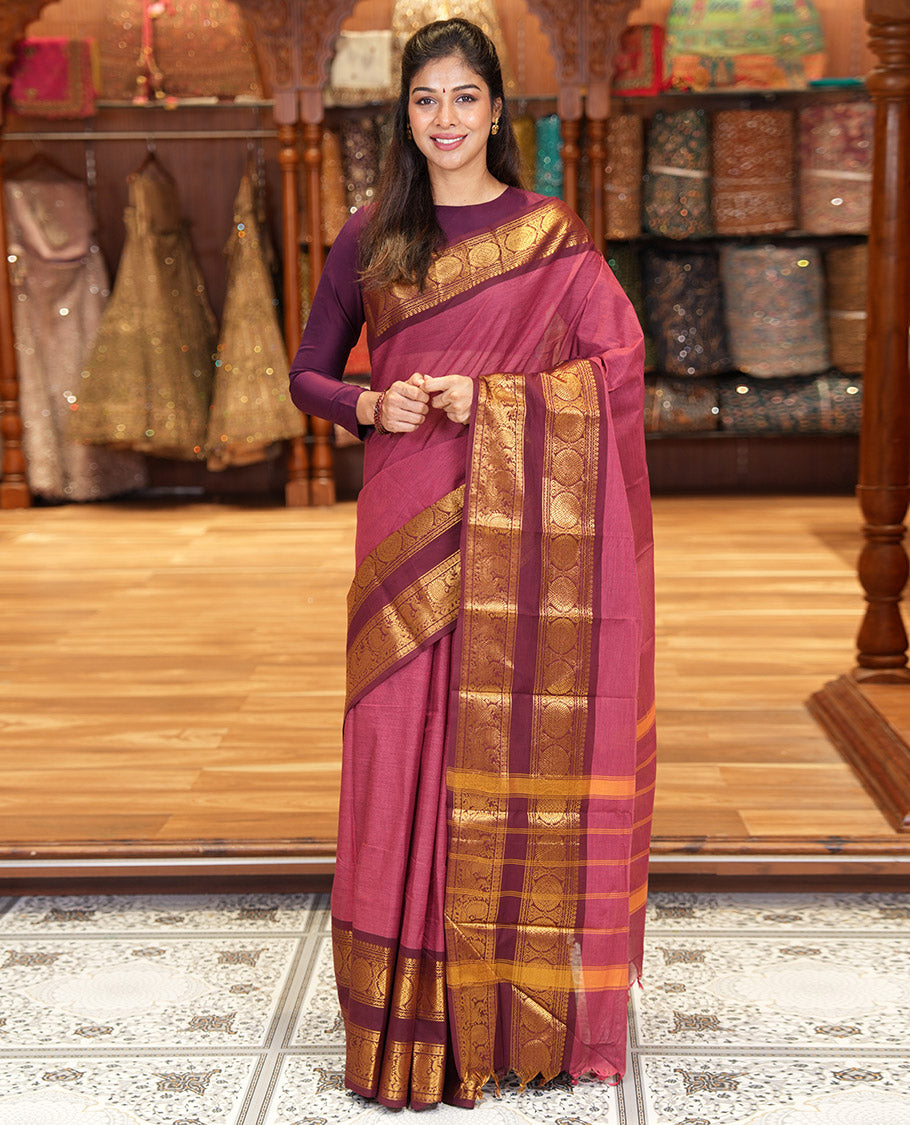 Reddish Brown Plain Chettinad Cotton Saree, Complemented by a Contrast Traditional Zari Border of  Peacock-Chakram Designs, Subtly Striped Pallu, and Paired with a Matching Blouse
