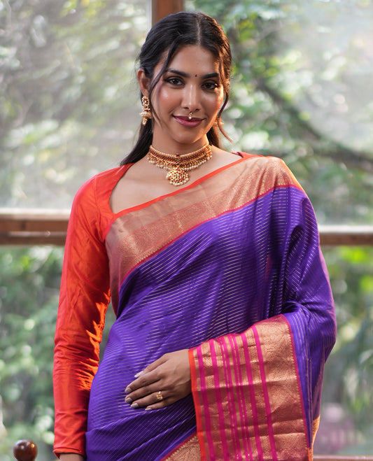 Violet and Pink Vasundhara Silk Saree, Enriched with Zari Stripes All Over Its Body, Complemented by Contrast Border of Thilakam Mokku, Muthu, Mayil, Neli, and Cross Kamalam Designs, Jaal Pallu, and Paired with a Veldhari With Bordered Blouse