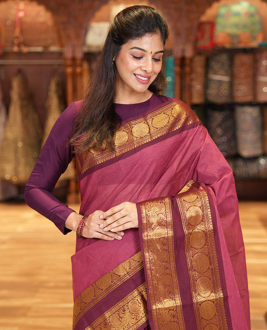 Reddish Brown Plain Chettinad Cotton Saree, Complemented by a Contrast Traditional Zari Border of  Peacock-Chakram Designs, Subtly Striped Pallu, and Paired with a Matching Blouse