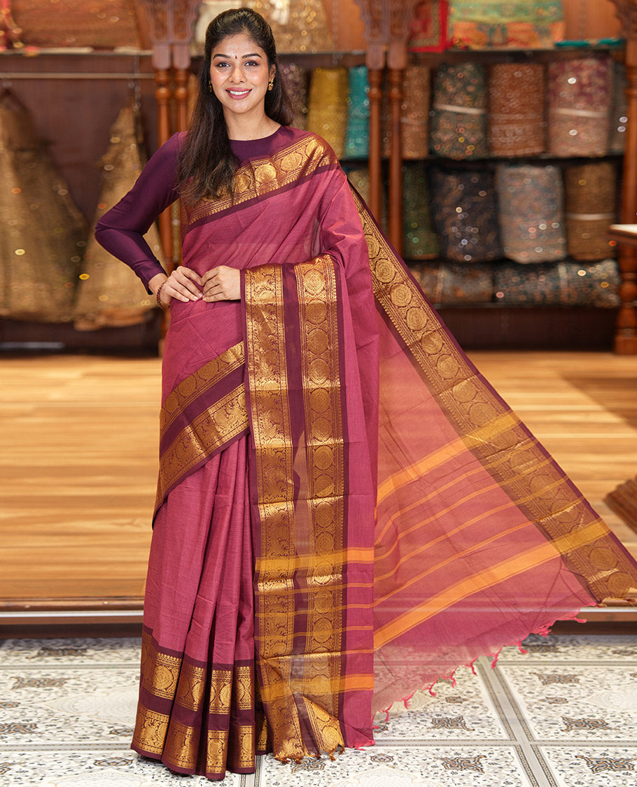 Reddish Brown Plain Chettinad Cotton Saree, Complemented by a Contrast Traditional Zari Border of  Peacock-Chakram Designs, Subtly Striped Pallu, and Paired with a Matching Blouse