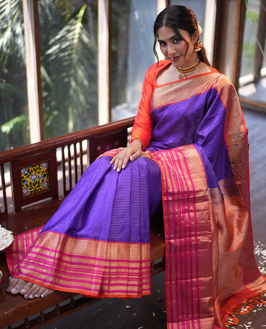Violet and Pink Vasundhara Silk Saree, Enriched with Zari Stripes All Over Its Body, Complemented by Contrast Border of Thilakam Mokku, Muthu, Mayil, Neli, and Cross Kamalam Designs, Jaal Pallu, and Paired with a Veldhari With Bordered Blouse