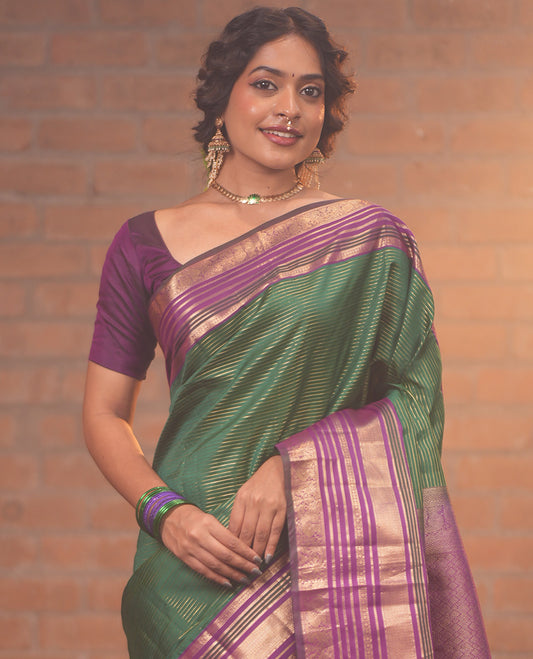 Green and Magenta Vasundhara Silk Saree, Enriched with Veldhari and Muthu Stripes On Its Body, Complemented by Contrast Border of Muthu, Lavangam, Neli, Mayil Kann, And Mayil Designs, Grand Pallu, and Paired with a Contrast Blouse
