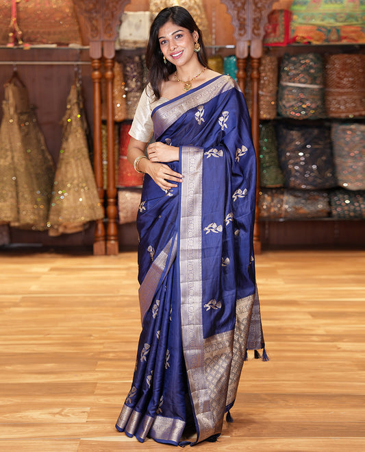 Navy Blue Semi-Banaras Satin Silk Saree, Dazzled with Floral Zari Buttas Across Its Body, Highlighted by Traditional Zari Design Border, Grand Zari Woven Palu of Jaal Designs, and Paired with a Matching Blouse
