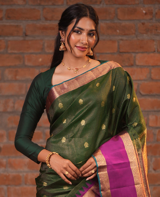 Dark Green and Magenta Vasundhara Silk Saree, Elevated with Zari Buttas and Zari Checks On Its Body, Complemented by Contrast Thazampoo Rekku Rettai Pettu Border of Salngai, and Mayil Designs, Grand Pallu, and Paired with a Contrast Blouse