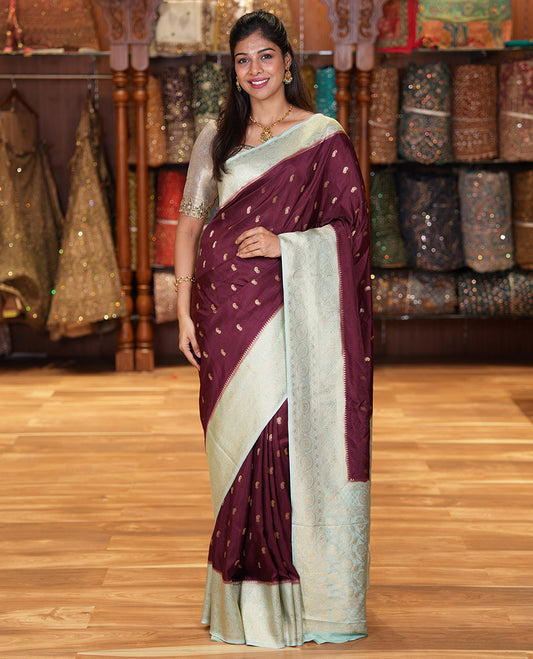 Coffee Brown Russian Dola Silk Saree, Adorned with Paisley Buttas All Over Its Body, Complemented by a Contrast Traditional Zari Design Border, Pallu of Floral Jaal Designs, and Paired with a Contrast Blouse