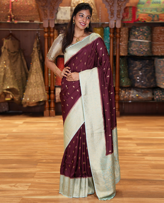 Coffee Brown Russian Dola Silk Saree, Adorned with Paisley Buttas All Over Its Body, Complemented by a Contrast Traditional Zari Design Border, Pallu of Floral Jaal Designs, and Paired with a Contrast Blouse