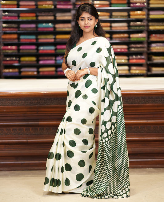 Borderless cream and green polka dots printed art khadi cotton saree, pallu steeped with polka dots, and a contrast tiny polka dots printed blouse