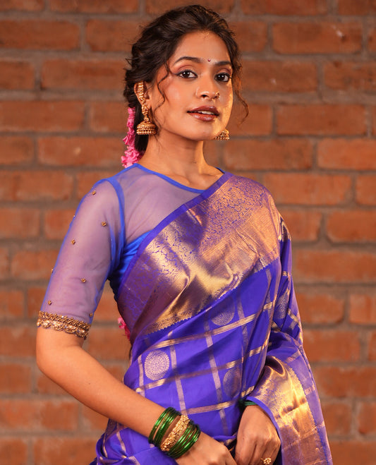 M.s Blue Vasundhara Silk Saree, Adorned with Round Mayil Butta Enclosed Checks, a Zari Border of Mayil Kann and Kodi Visiry, Jaal Pallu, and Paired with a Matching Blouse