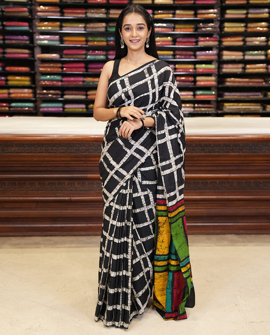 Black checked batik printed mul cotton saree, contrast kaleidoscope colored batik printed pallu, and a contrast batik printed blouse