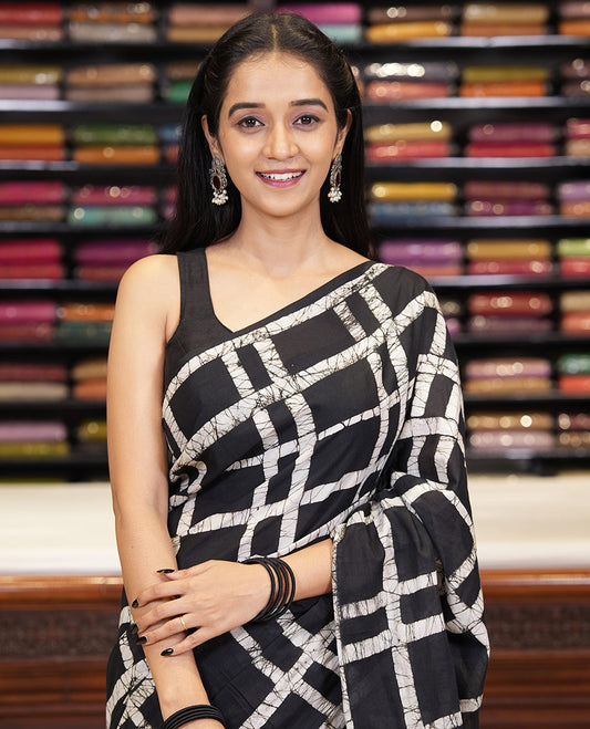 Black checked batik printed mul cotton saree, contrast kaleidoscope colored batik printed pallu, and a contrast batik printed blouse