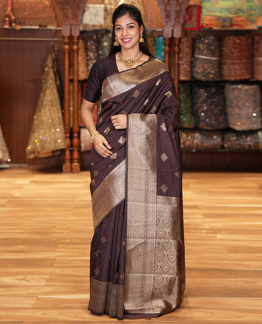 Coffee Brown Litchi Silk Saree, Mesmerized with Kolam Buttas All Over Its Body, Highlighted by a Traditional Zari Designs Woven Border, Grand Pallu of Intricate Designs, and Paired with a Matching Blouse