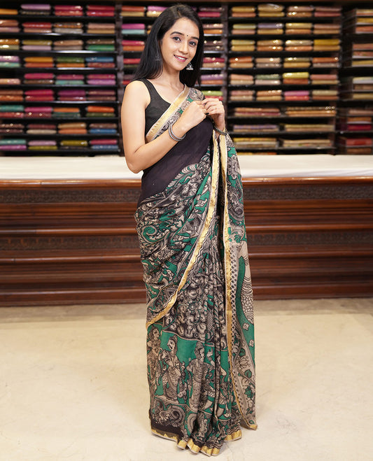 Green kalamkari floral, peacock, and human figurines printed Kota cotton saree, contrast printed border, peacock printed pallu, and a contrast floral printed blouse