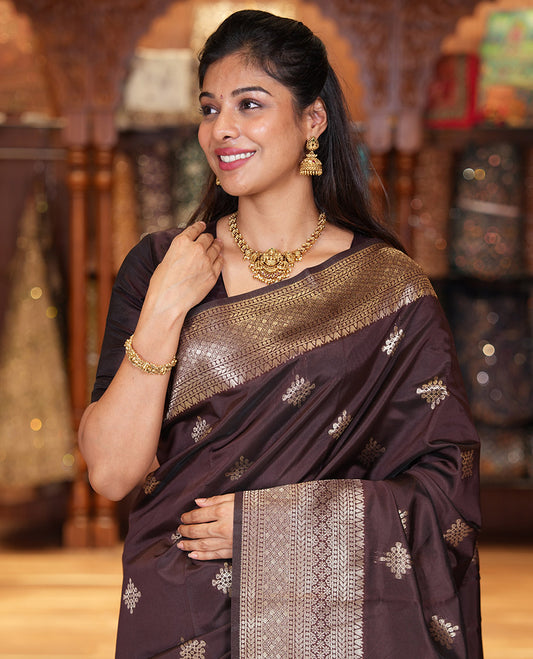 Coffee Brown Litchi Silk Saree, Mesmerized with Kolam Buttas All Over Its Body, Highlighted by a Traditional Zari Designs Woven Border, Grand Pallu of Intricate Designs, and Paired with a Matching Blouse