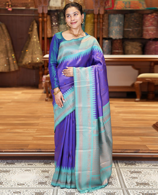 Blue Litchi Saree, Gracefully Embellished with Zari Buttas and Micro-Zari Checks on Its Body, Complemented by a Contrast Traditional Temple Border of Peacock and Rudraksham Designs, an Opulently Embellished Pallu, and Paired with a Contrast Blouse