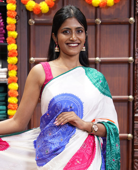 White base multi-color bandhani dots enclosed circle printed with mirror work moss chiffon saree, contrast piping border, pallu of print, stone work and mirror work